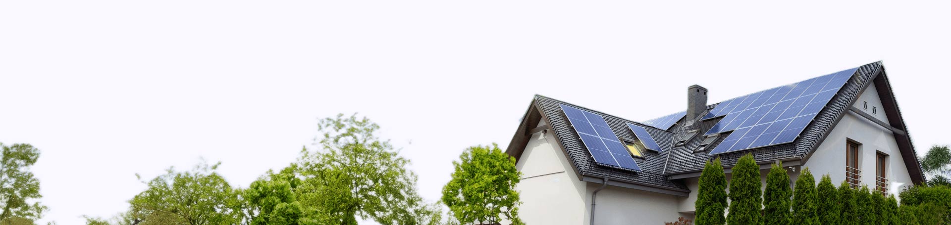 House with solar panels on the roof and surrounded by trees.